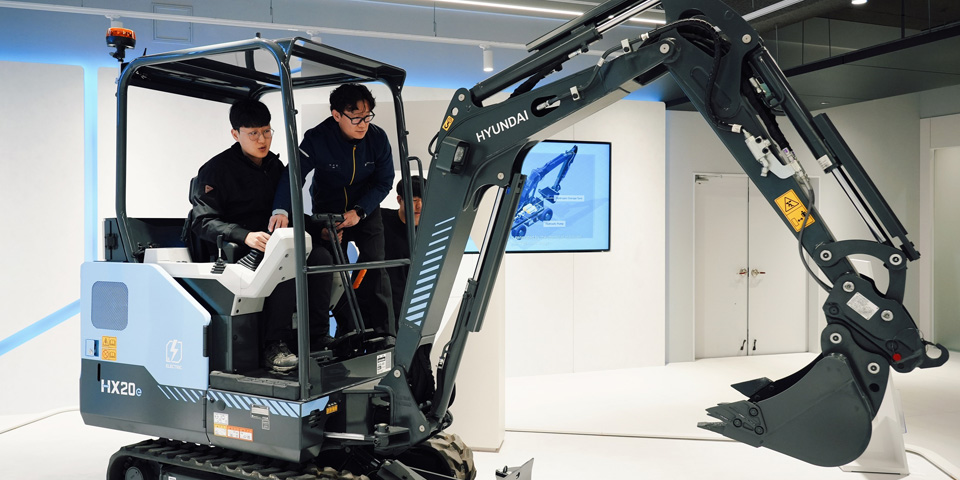 Employees at the HD Construction Equipment’s Eumseong Global Training Center engage in practical training with a mini electric excavator.