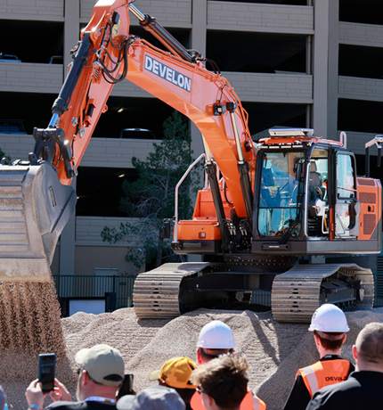 An unmanned autonomous excavator with an empty cab is being showcased at CONEXPO 2026, the North American construction equipment exhibition.